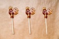 Sugar lollipop roosters on wooden paper