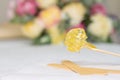 sugar paste or wax honey for hair removing with wooden waxing spatula sticks. flower background - depilation and beauty concept.