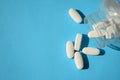 Sugar pills, artificial sweeteners. Close up white pills with a bottle on a blue Royalty Free Stock Photo