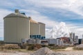 Sugar production factory with chimneys expelling smoke outside