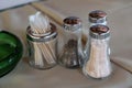 Sugar, Salt and Pepper Shakers and Some Toothpicks on a Table Royalty Free Stock Photo