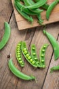 Sugar snap peas on wooden background.