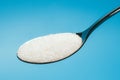 Sugar spoon blue background. Royalty Free Stock Photo