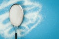 Sugar spoon blue background. Royalty Free Stock Photo