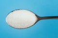Sugar spoon blue background. Royalty Free Stock Photo