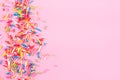 Sugar sprinkle dots hearts, decoration for cake and bakery, as a background. Isolated on pink. Royalty Free Stock Photo