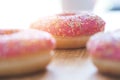 Sugar addiction: Close up of sugar sprinkled pink donut Royalty Free Stock Photo