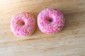 Sugar addiction: Close up of sugar sprinkled pink donut Royalty Free Stock Photo