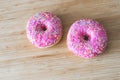Sugar addiction: Close up of sugar sprinkled pink donut Royalty Free Stock Photo
