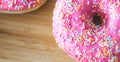 Sugar addiction: Close up of sugar sprinkled pink donut
