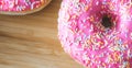 Sugar addiction: Close up of sugar sprinkled pink donut Royalty Free Stock Photo