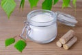 Sugar substitute xylitol, a glass jar with birch sugar, liefs and wood