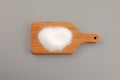 Sugar substitute Xylitol, Xylit powder or birch sugar on wooden board. Food additive E967, sweetener, moisture-retaining agent,