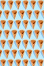 Sugar waffle cone for ice cream arranged in pattern on mint background. The image with copy space can be used as a