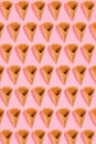 Sugar waffle cone for ice cream arranged in pattern on pink background. The image with copy space can be used as a Royalty Free Stock Photo