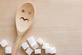 Sugar with wooden spoon on cutting board, unhealthy food additives concept