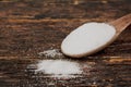 Sugar on a wooden spoon on table