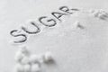 Sugar Word. White Sugar On Background