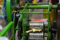 Sugarcane juice pressing machine is extracting juice from sugarcane sticks in traditional method. This is a very popular Royalty Free Stock Photo