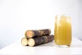 Fresh squeezed sugar cane juice with fresh cane sliced isolated on white background. Royalty Free Stock Photo