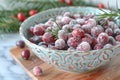 Sugared cranberries in decorative bowl with rosemary