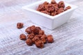 Sugared Hazelnuts in a white bowl on a wooden background. Hazelnuts in sugar glaze. Selective focus. Royalty Free Stock Photo