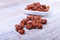 Sugared Hazelnuts in a white bowl on a wooden background. Hazelnuts in sugar glaze. Selective focus. Royalty Free Stock Photo