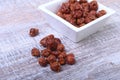 Sugared Hazelnuts in a white bowl on a wooden background. Hazelnuts in sugar glaze. Selective focus. Royalty Free Stock Photo