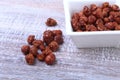 Sugared Hazelnuts in a white bowl on a wooden background. Hazelnuts in sugar glaze. Selective focus. Royalty Free Stock Photo