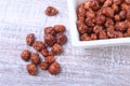 Sugared Hazelnuts in a white bowl on a wooden background. Hazelnuts in sugar glaze. Selective focus. Royalty Free Stock Photo