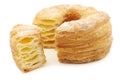 Sugared puff pastry donut with a cut piece