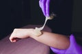 Sugaring. Beauty Concept. Young beautiful girl with dark hair gets the procedure for hair removal liquid sugar