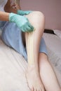Sugaring beauty procedure. Removing hair on women`s legs. Procedure sugaring in a beauty salon. Sugar depilation