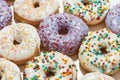 Sugary food. Close up shot of assorted round glazed donuts with colorful sprinkles, top view Royalty Free Stock Photo