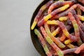 Sugary Sour Gummy Worms in a Bowl, top view. Copy space Royalty Free Stock Photo