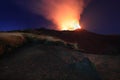 Suggestiva eruzione del vulcano Etna con esplosione di lava dalla cima del cratere con sfondo il cielo stellato e paesaggio Royalty Free Stock Photo