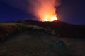 Suggestiva eruzione del vulcano Etna con esplosione di lava dalla cima del cratere con sfondo il cielo stellato e paesaggio Royalty Free Stock Photo