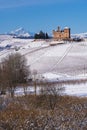 Suggestive view of the Castle of Grinzane Cavour on the snowy hills and vineyards Royalty Free Stock Photo