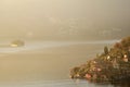 An suggestive view of Lake Iseo at sunset with the fog Royalty Free Stock Photo