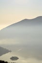 An suggestive view of Lake Iseo at sunset with the fog Royalty Free Stock Photo