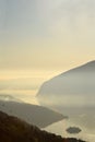 An suggestive view of Lake Iseo at sunset with the fog Royalty Free Stock Photo