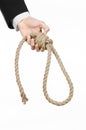 Suicide and business topic: Hand of a businessman in a black jacket holding a loop of rope for hanging on white isolated Royalty Free Stock Photo