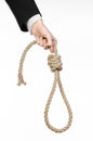 Suicide and business topic: Hand of a businessman in a black jacket holding a loop of rope for hanging on white isolated