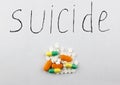 A suicide handful of pills on a white background suicide Royalty Free Stock Photo