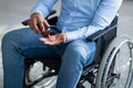 Suicide in people with disability. Handicapped young man pouring handful of pills from jar, closeup