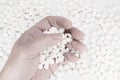 Suicide Pills, Pills, tablets in dead man`s hand by overdosing on medication. Top view close up of overdose pills on white backgr