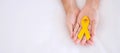 Suicide prevention and Childhood Cancer Awareness, Yellow Ribbon for supporting people living and illness. children Healthcare and Royalty Free Stock Photo