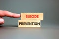 Suicide prevention symbol. Concept words Suicide prevention on wooden blocks. Beautiful grey table grey background. Psychologist