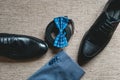 Suit, blue bow tie, leather black shoes and belt. Grooms wedding morning. Close up of modern man accessories Royalty Free Stock Photo