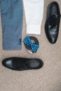 Suit, blue bow tie, leather black shoes and belt. Grooms wedding morning. Close up of modern man accessories Royalty Free Stock Photo